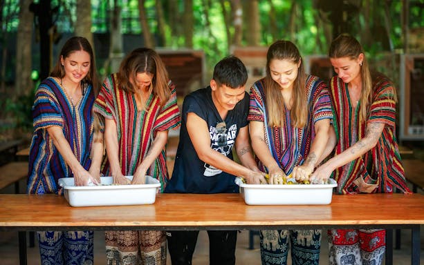 Visitors preparing food for elephants at Elephant Jungle Sanctuary, Phuket.
