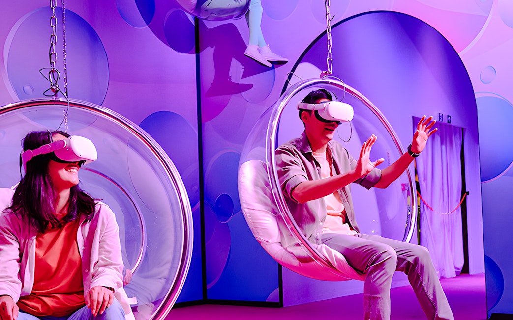 Visitors enjoying virtual reality in bubble chairs at Bubble Planet, Washington DC.