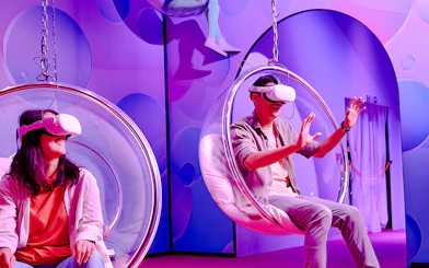 Visitors enjoying virtual reality in bubble chairs at Bubble Planet, Washington DC.