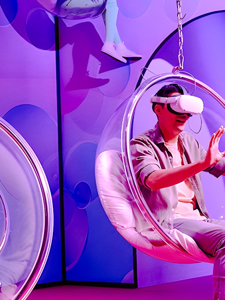 Visitors enjoying virtual reality in bubble chairs at Bubble Planet, Washington DC.