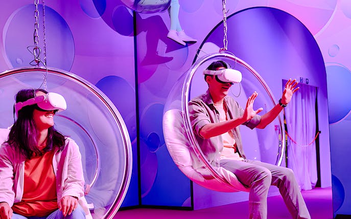 Visitors enjoying virtual reality in bubble chairs at Bubble Planet, Washington DC.