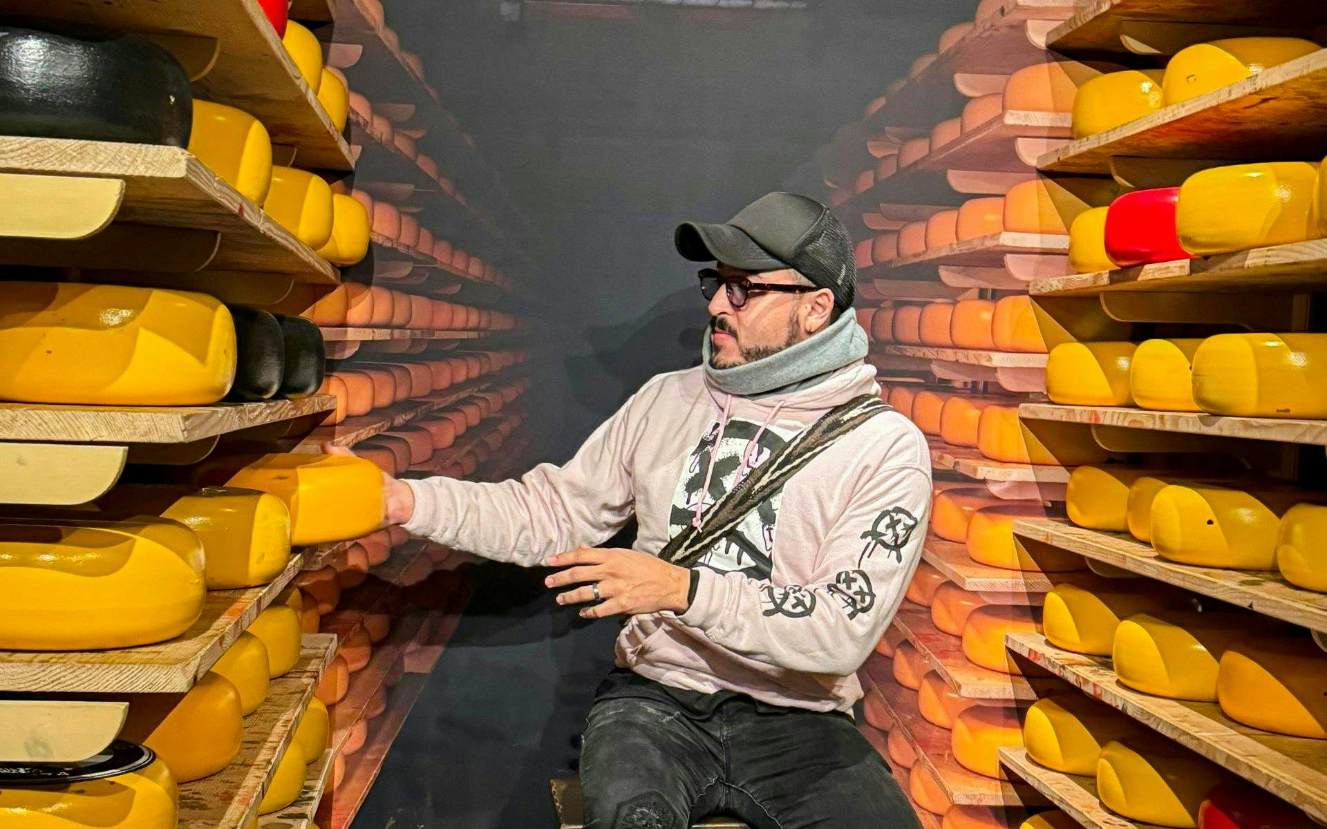 Cheese tasting room with shelves of cheese wheels on the Zaanse Schans Volendam and Giethoorn Tour.