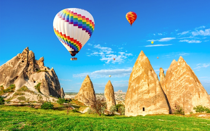Hot air balloons over Cappadocia's unique rock formations in Central Anatolia.