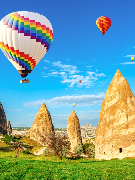 Hot air balloons over Cappadocia's unique rock formations in Central Anatolia.