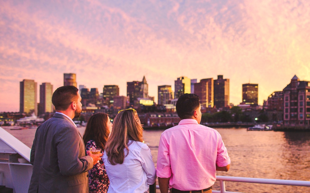 Guests enjoying Boston skyline on sunset cruise.