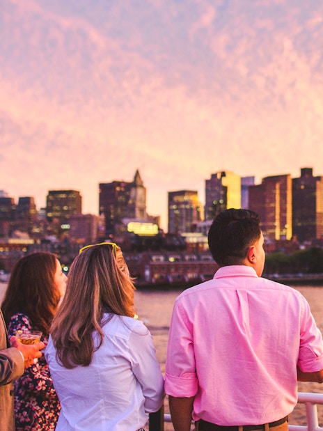 Guests enjoying Boston skyline on sunset cruise.