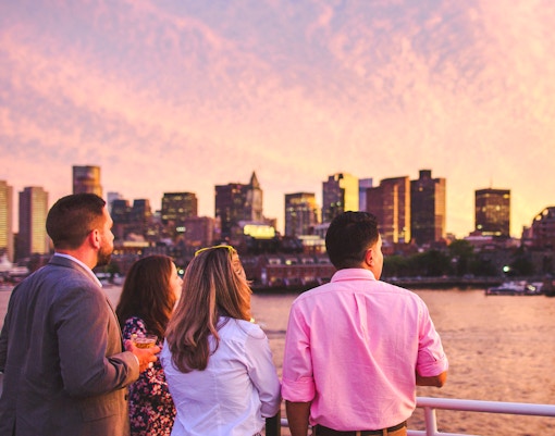 Guests enjoying Boston skyline on sunset cruise.