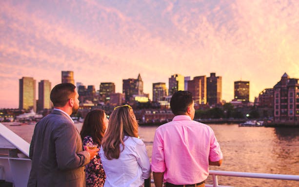 Guests enjoying Boston skyline on sunset cruise.