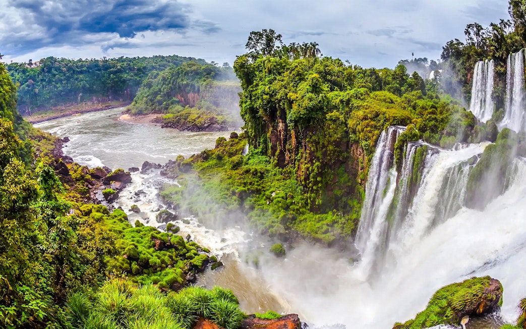 Argentine Falls with lush greenery and cascading water.