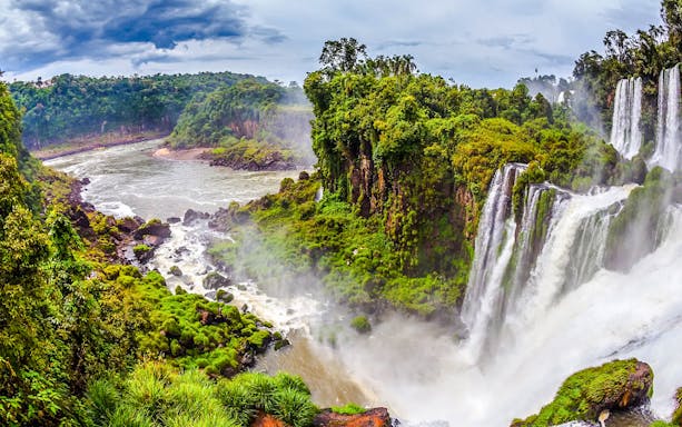 Argentine Falls with lush greenery and cascading water.