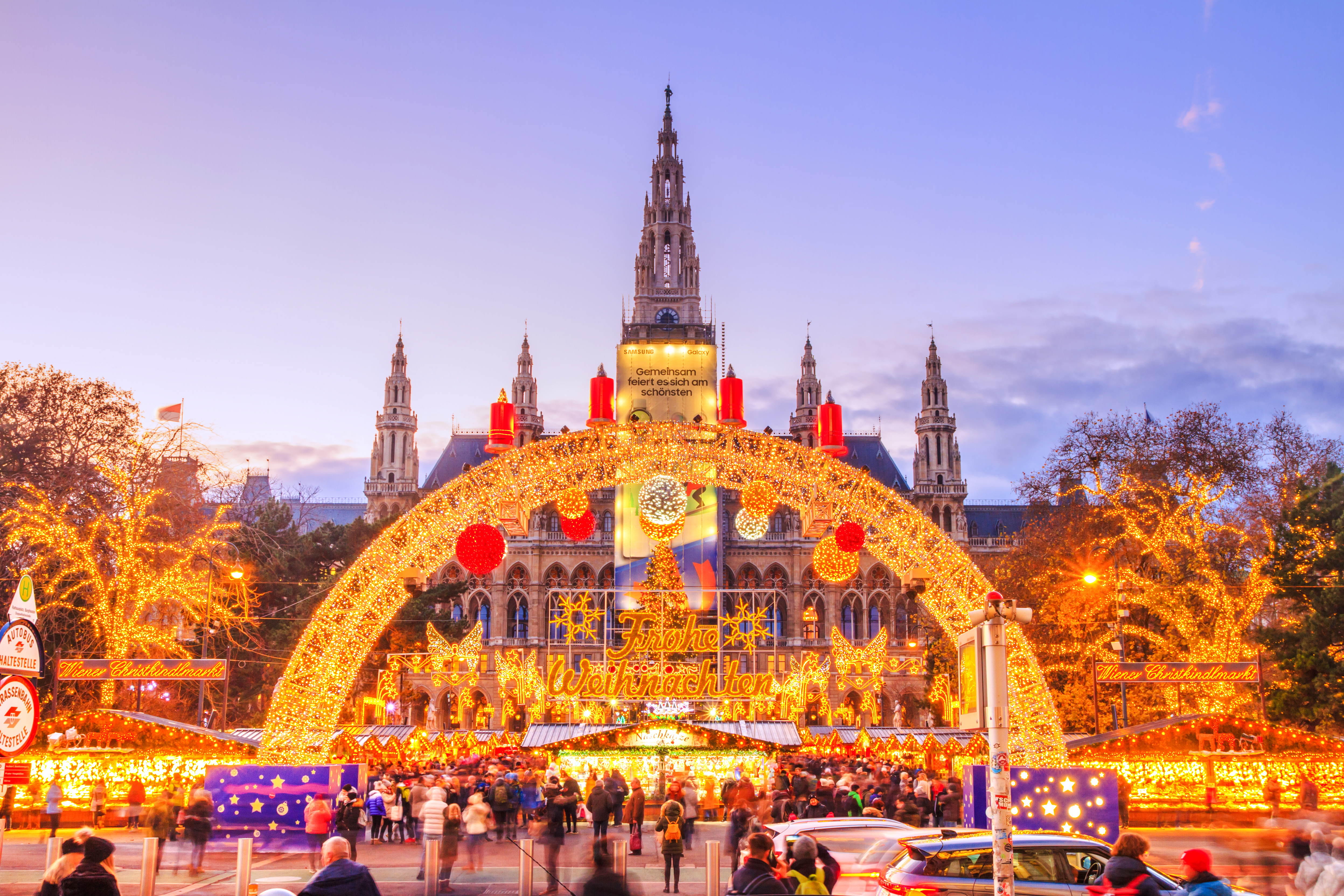 Rathausplatz Christmas market in Vienna with illuminated decorations and festive crowds.