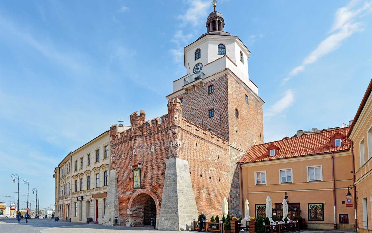 Lublin's historic Krakow Gate on a sunny day during a small group tour from Warsaw.