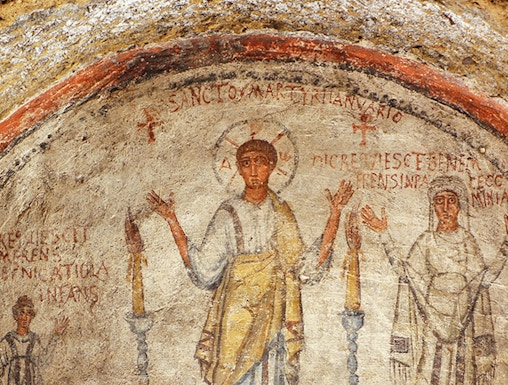 Fresco in the Catacombs of San Gennaro, Naples, depicting early Christian figures.