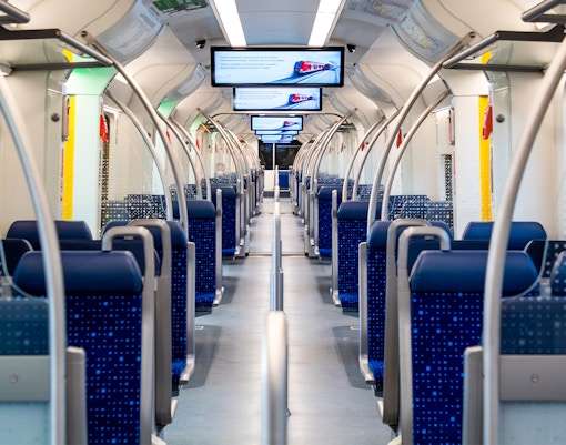Munich Airport train transfer with passengers boarding at the platform.