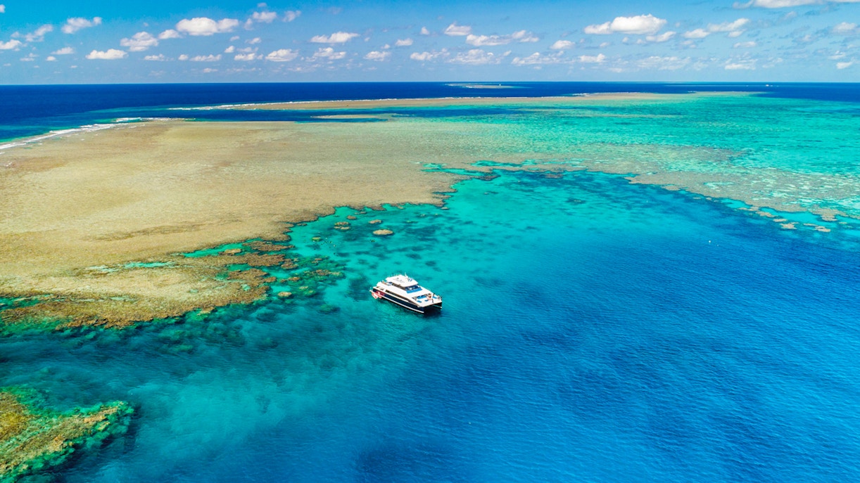 Cruise boat near coral reef on Port Douglas to Low Isles Island snorkel tour.