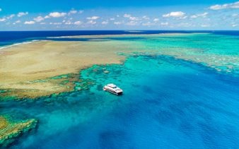 Cruise boat near coral reef on Port Douglas to Low Isles Island snorkel tour.
