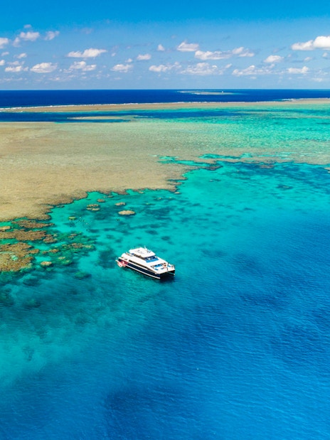 Cruise boat near coral reef on Port Douglas to Low Isles Island snorkel tour.