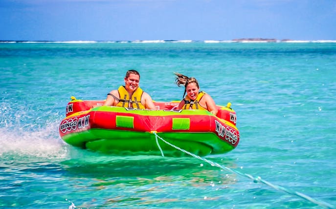 People enjoying a water tubing ride on the east coast of Mauritius.