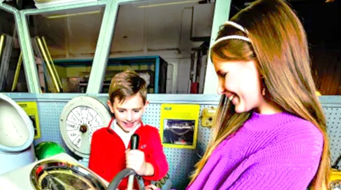 Children exploring ship controls at the Intrepid Museum, New York.