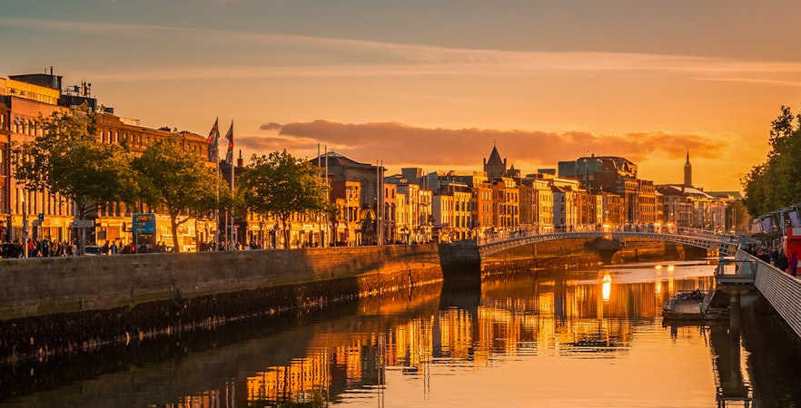 Dublin city center skyline at golden hour with historic buildings and River Liffey, Ireland.