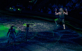 Performer swinging above water during La Perle show in Dubai.