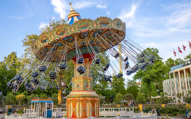Swing ride at Tivoli Gardens, Copenhagen, with colorful seats and ornate design.