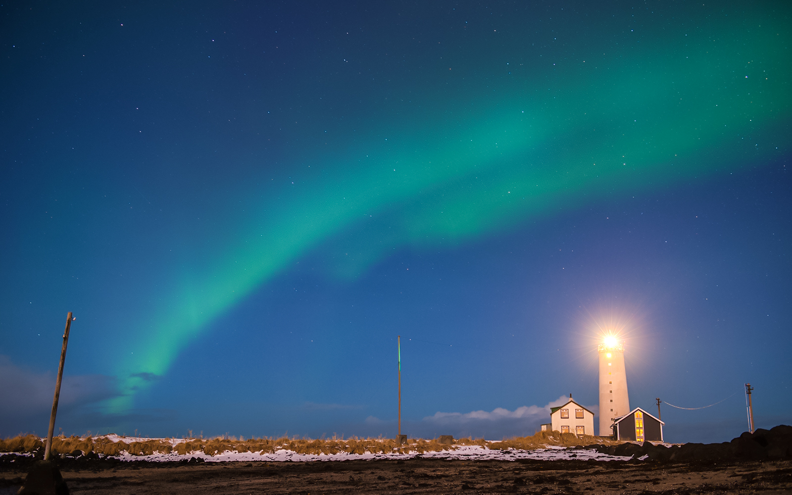 Grótta Lighthouse in Reykjavik with Northern Lights in the sky.