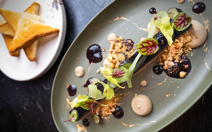 Lunch set menu dish with garnish at CÉ LA VI Dubai, featuring Burj Khalifa views.