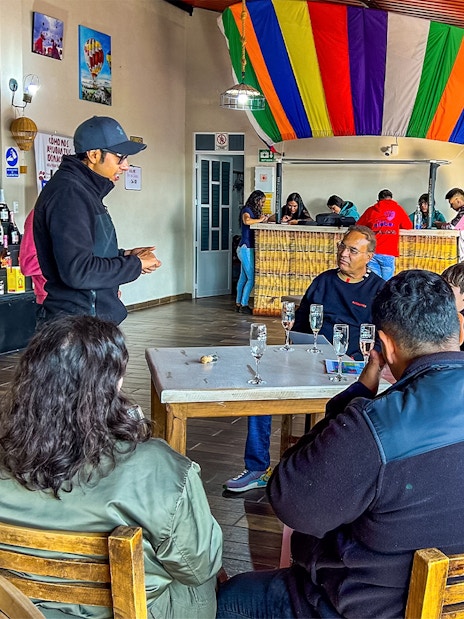 Guests enjoying a toast after a hot air balloon flight in a colorful venue.