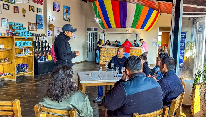 Teotihuacan hot air balloon landing with passengers toasting with champagne.