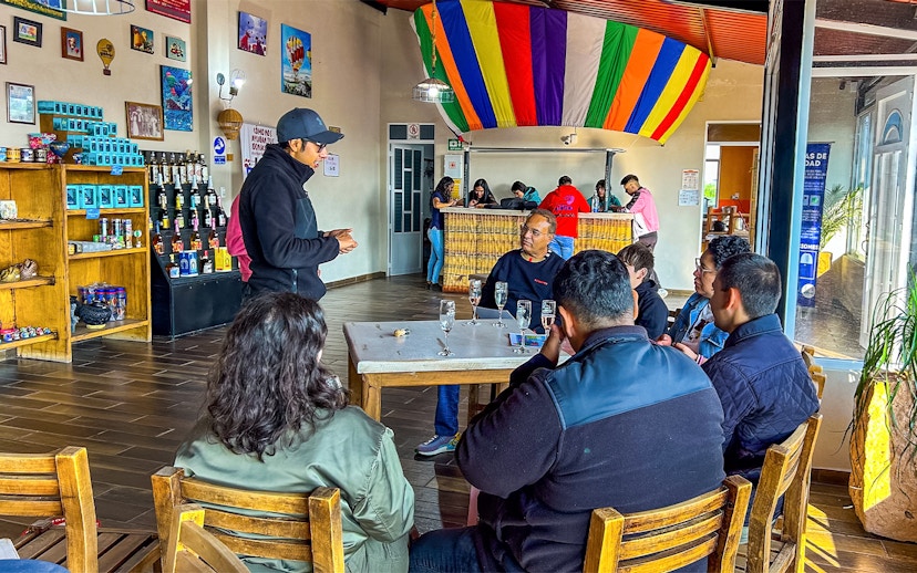 Guests enjoying a toast after a hot air balloon flight in a colorful venue.