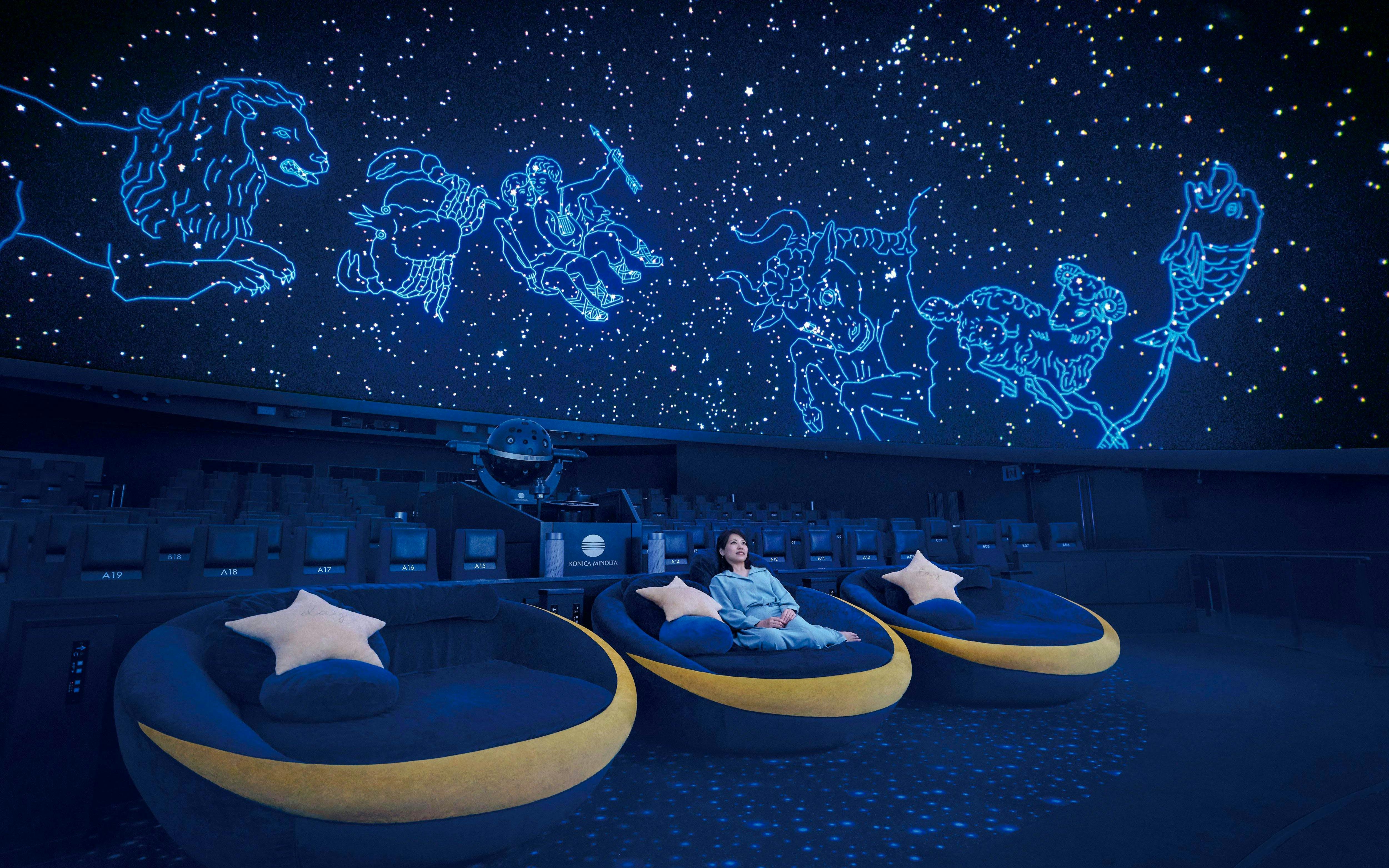 Tourist seated in Crescent Moon Seats at Konica Minolta Planetarium Tenku, Tokyo Skytree.