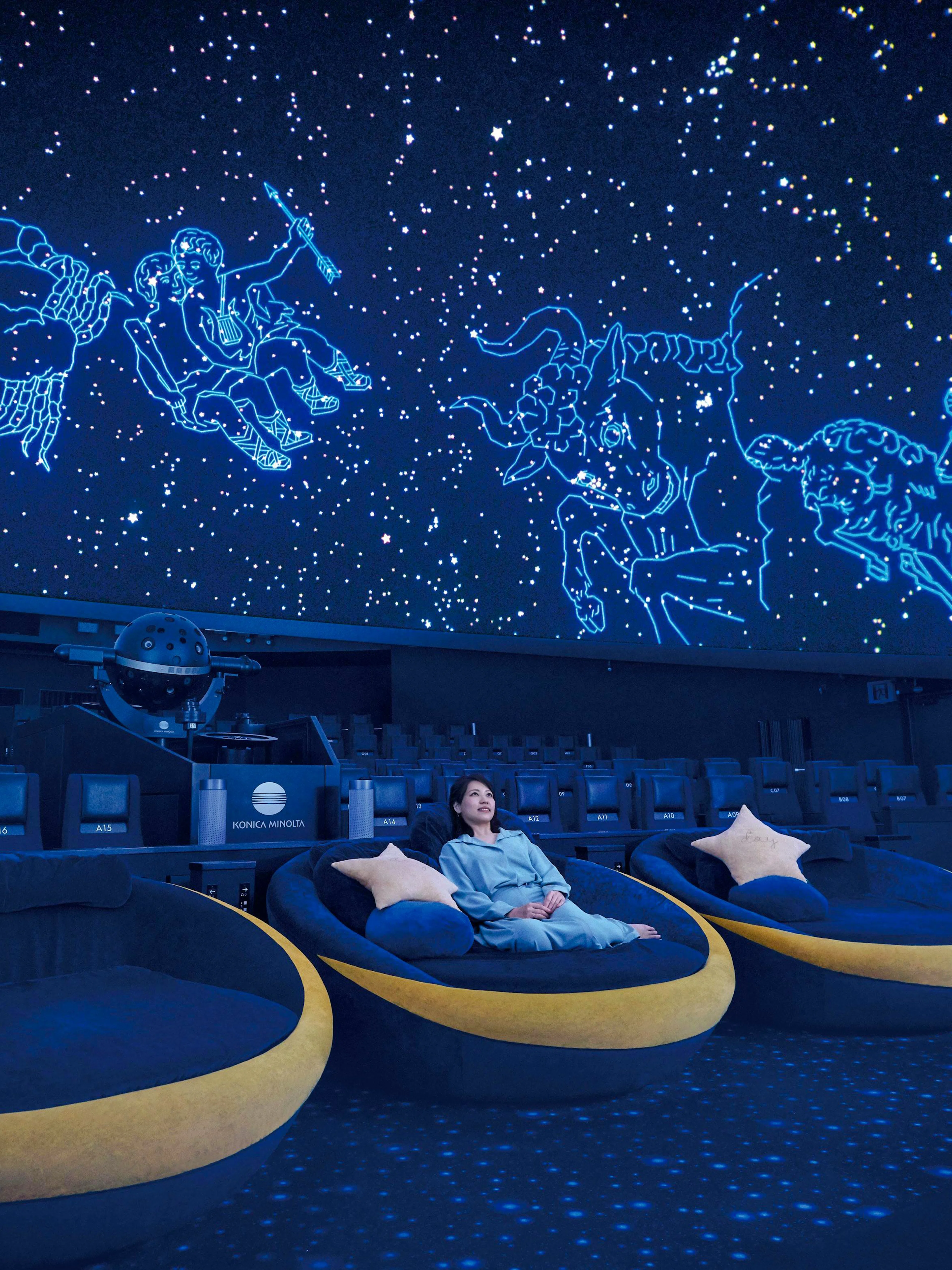 Tourist seated in Crescent Moon Seats at Konica Minolta Planetarium Tenku, Tokyo Skytree.