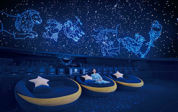 Tourist seated in Crescent Moon Seats at Konica Minolta Planetarium Tenku, Tokyo Skytree.