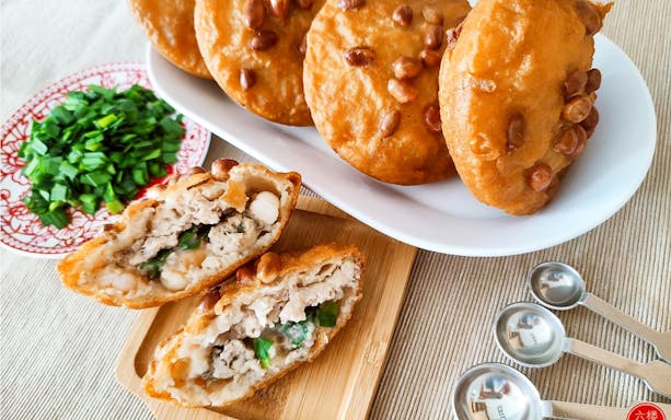 Chinatown hawker food with stuffed pastries and chopped green onions in Singapore.