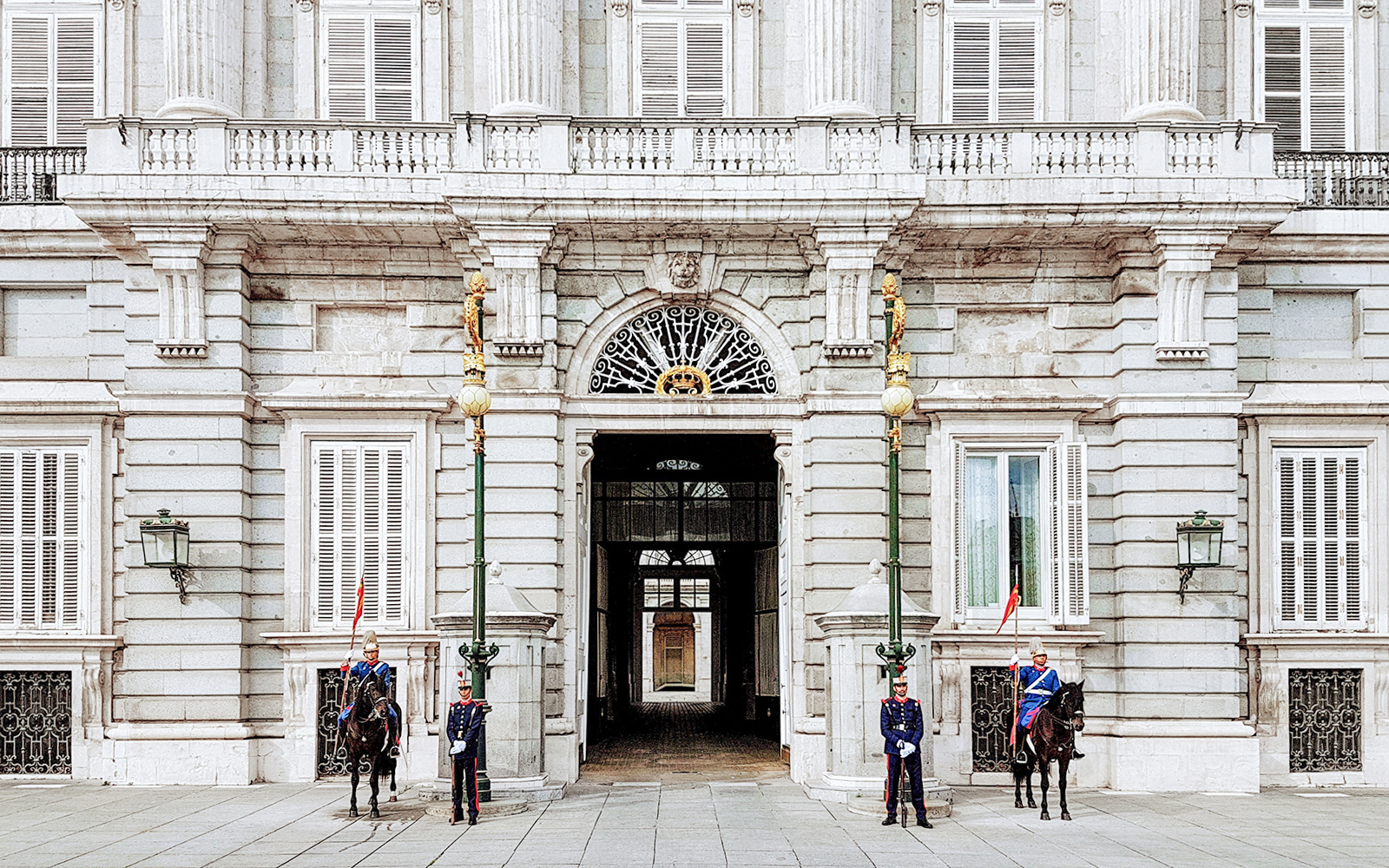 Guards at the entrance of the Royal Palace of Madrid during a guided tour.
