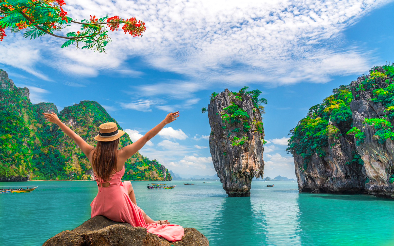 Woman enjoying view of Phang Nga Bay Islands with limestone cliffs and turquoise water.