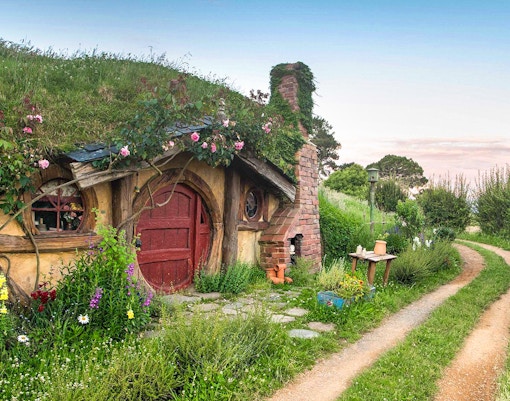 Hobbiton Movie Set house with round door and garden path in New Zealand.