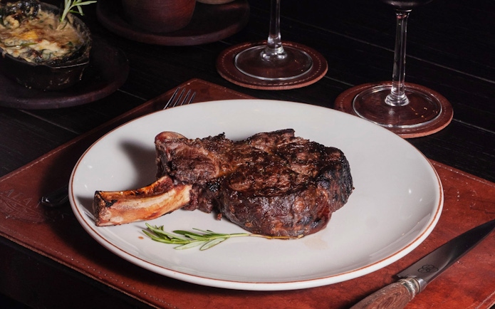 Dry-aged bone-in ribeye steak at Michelangelo Tango Show, Buenos Aires.