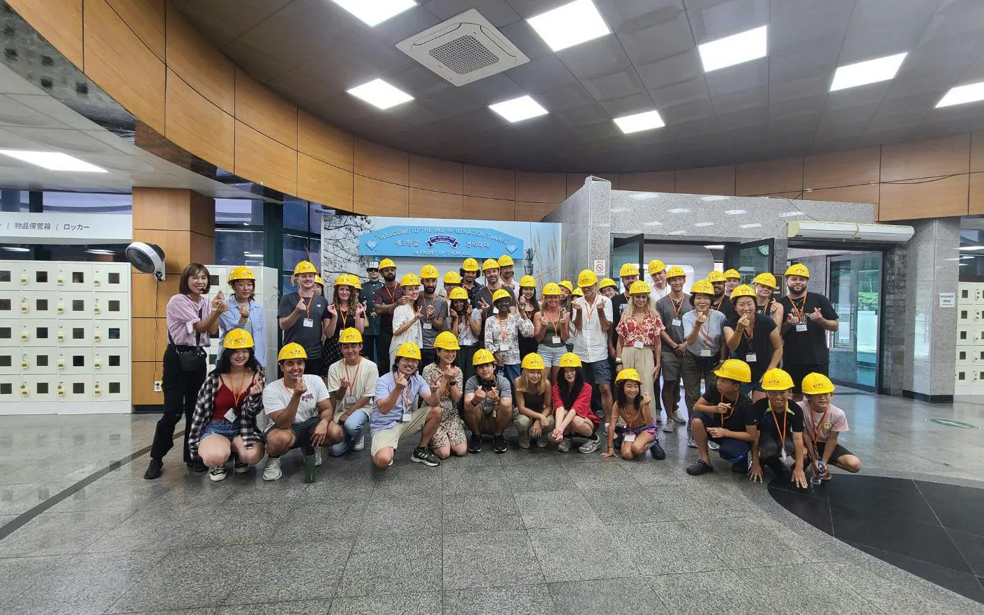 Tour group wearing yellow helmets at DMZ 3rd Tunnel entrance, South Korea.
