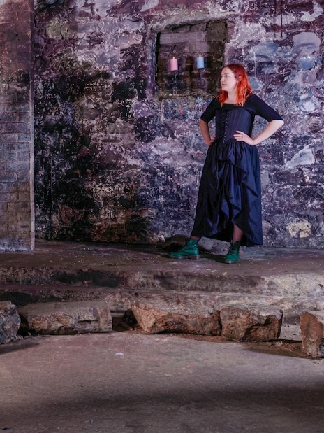 Tour group listening to a guide in the historic Edinburgh Vaults.