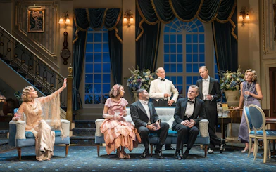 Cast of "Hay Fever" performing in a West End theater living room scene.