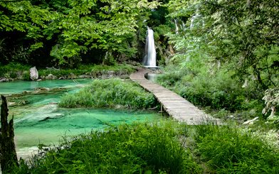 Wooden path leading to a waterfall at Plitvice Lakes National Park, Croatia.