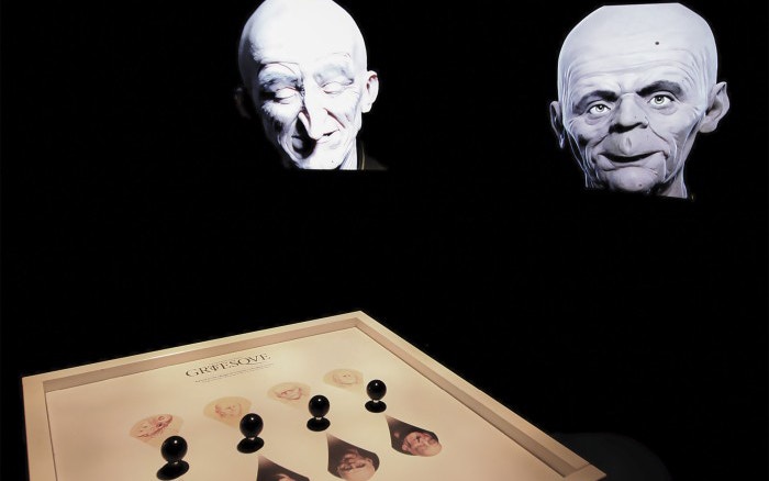 Grotesque heads exhibit at Leonardo3 Museum, featuring interactive display.