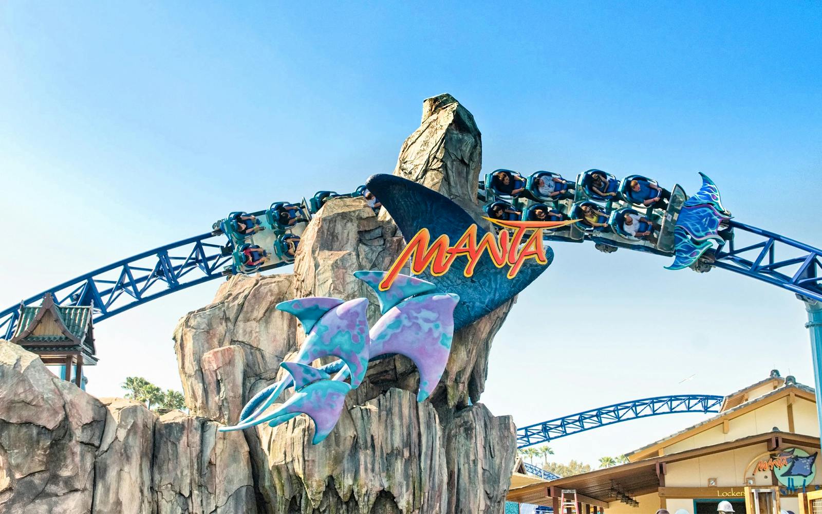 Roller coaster on Manta ride at SeaWorld San Diego with passengers on track.