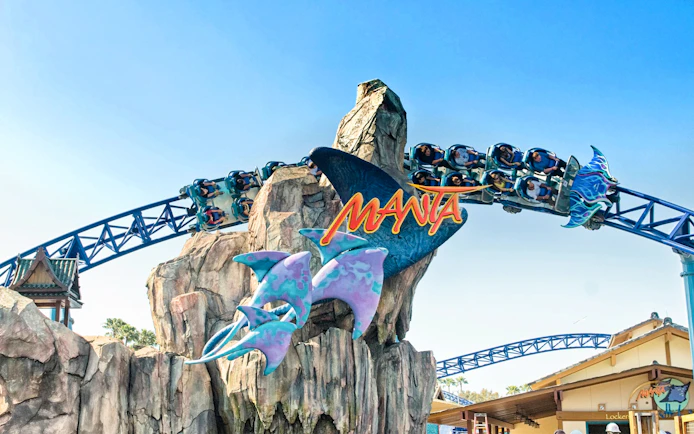 Roller coaster on Manta ride at SeaWorld San Diego with passengers on track.