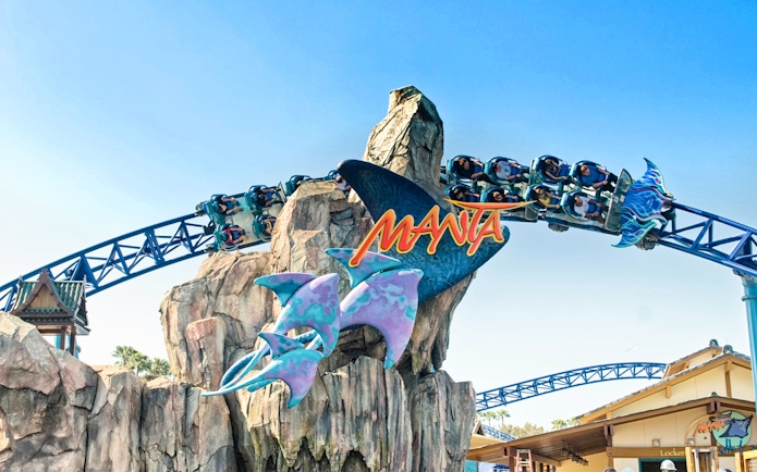 Roller coaster on Manta ride at SeaWorld San Diego with passengers on track.