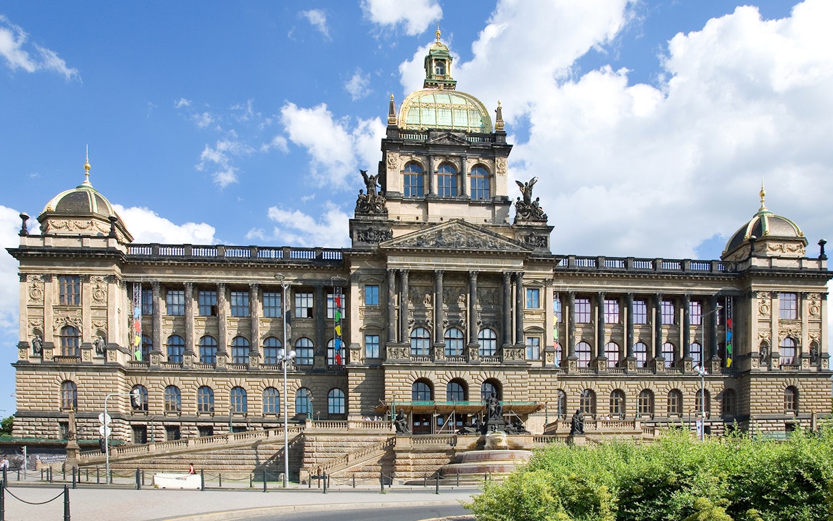 Prague National Museum facade under a clear blue sky.