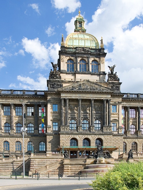 Prague National Museum facade under a clear blue sky.