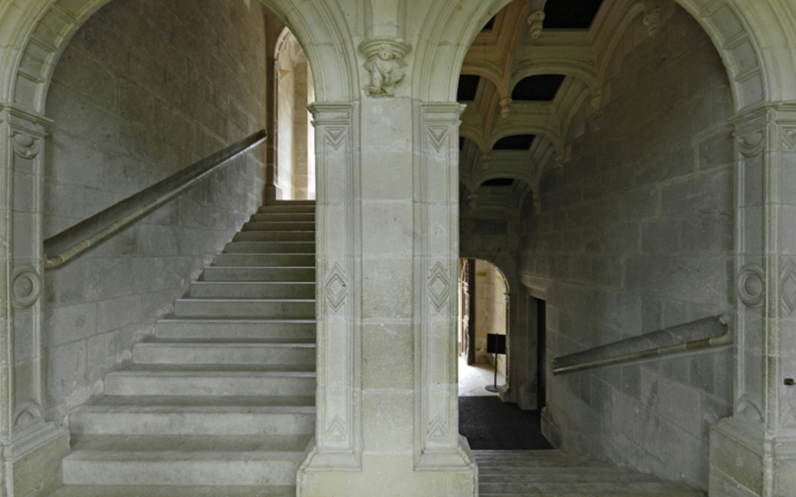 Grand staircase with stone arches at Azay-le-Rideau, France.